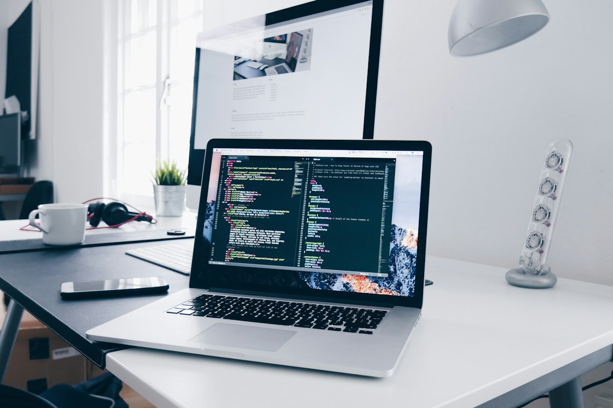 Laptop in a digital workspace representing connected analytics, optimization, design, and strategy services